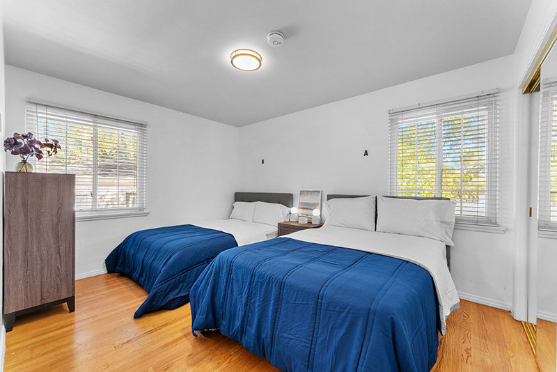 Bedroom with two beds dressed in navy bedding