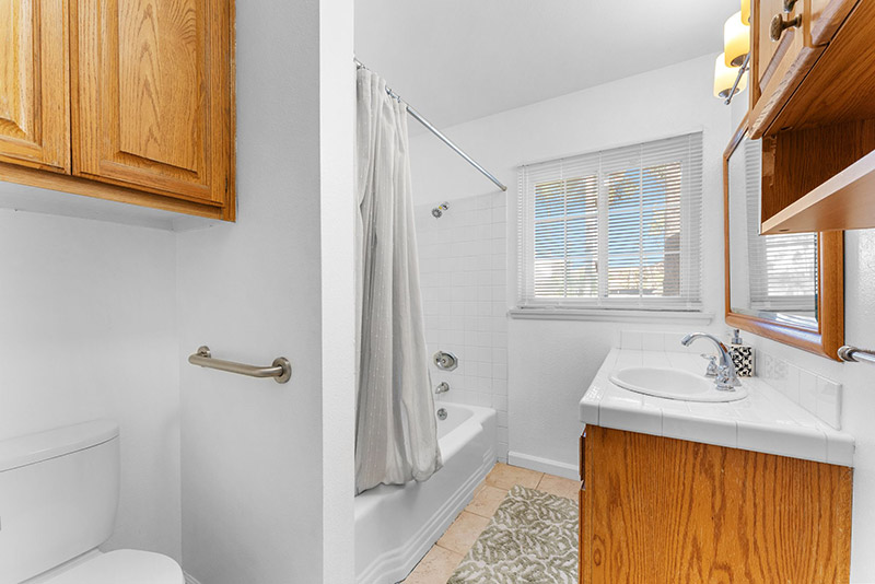 Bathroom with a tub-and-shower combination and a safety grab bar