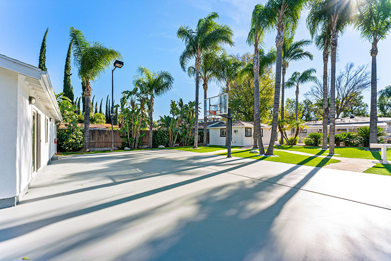 Outdoor basketball court alongside the main house