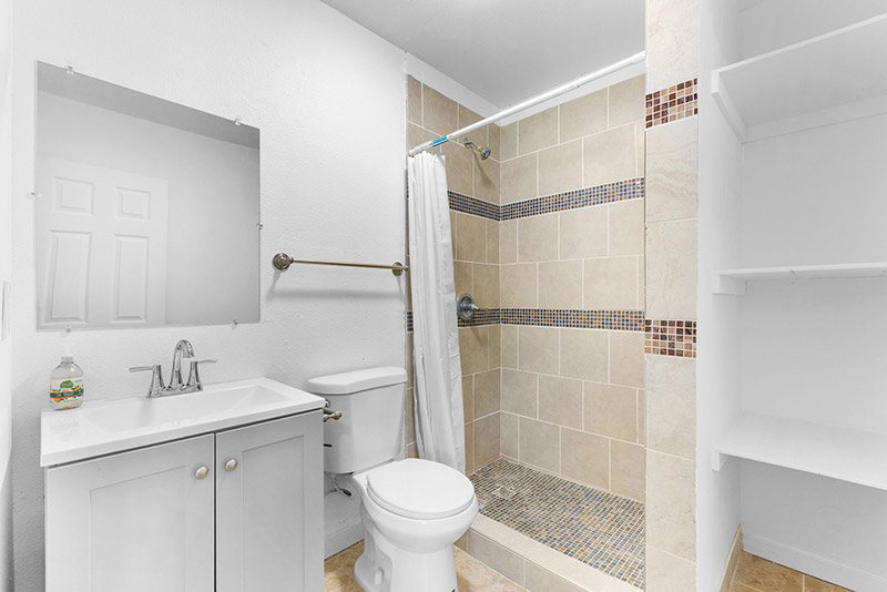 Bathroom in the guest cottage with a walk-in mosaic-tile shower